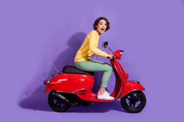 Fototapeta na wymiar Profile side view of her she nice attractive cheerful cheery girl riding bike having fun fast speed road way traveling isolated over bright vivid shine vibrant lilac violet purple color background