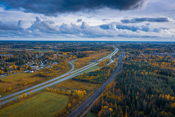 aerial view of highway in autumn with dramatic sky