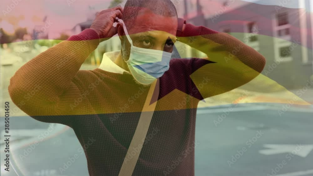 Wall mural Ghana flag waving against man wearing face mask