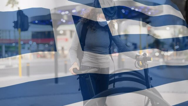 Greek flag waving against woman wearing face mask holding her bicycle