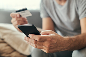 Man shopping online with mobile phone and credit card