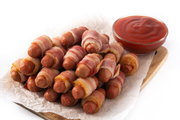 Pig in blankets. Sausages wrapped in smoked bacon isolated on white background