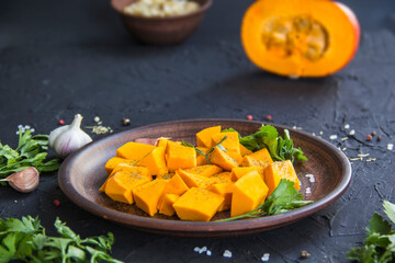 Beautifully chopped pumpkin slices, herbs, and ingredients for the dish. Creative atmospheric decoration