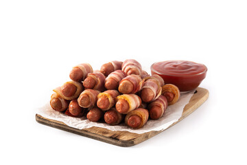Pig in blankets. Sausages wrapped in smoked bacon isolated on white background