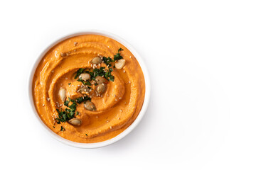 Pumpkin hummus in bow isolated on white background .Top view. Copy space