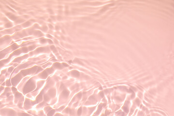 de-focused. Closeup of pink transparent clear calm water surface texture with splashes and bubbles....