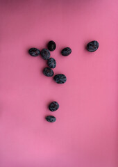 Plums isolated on pink background. Still life photography. Fruit pattern. Minimal, colorful photography.