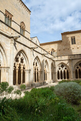 Fototapeta na wymiar Vertical view of the Cistercian Monastery from the garden of the cloister of Poblet, Tarragona, Spain, September 24, 2020