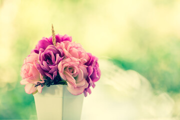 vintage bouquet roses flower on table with blur tree background.