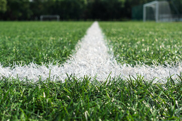 Green artificial grass turf soccer football field background