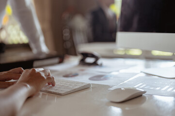Office workers work using computers to find information..Sales summary meeting,meeting and business concepts.