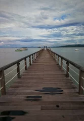 Foto auf Acrylglas wooden pier in the sea © Alec