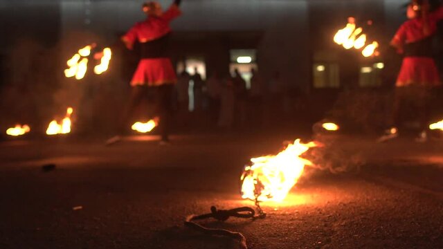 Demonstration performance with fire, fire show. Girls with fire in their hands show tricks, background, slow motion