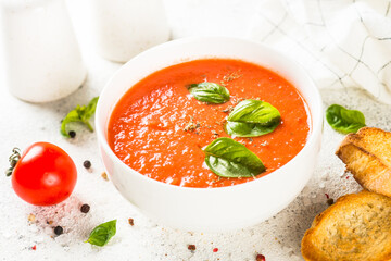 Tomato soup at white table.
