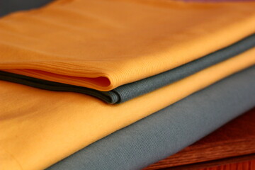 fabric jersey folded in a pile for cutting / combination of emerald and lemon