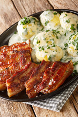 Grilled pork belly with parsley sauce stegt flaesk med persillesovs closeup on the plate on the table. Vertical