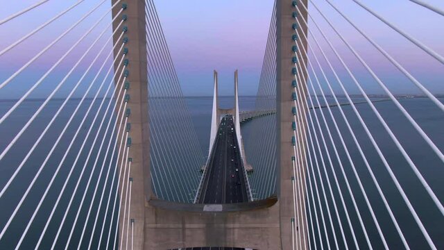 Aerial view of architectural landmark Vasco da Gama Bridge over the Tagus River at dusk in Lisbon, Portugal. The Vasco da Gama Bridge is the longest bridge in the European Union.