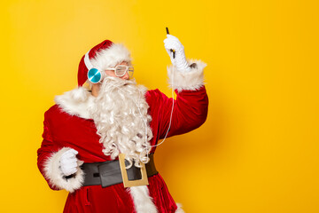 Fototapeta na wymiar Santa Claus wearing headset and listening to the music