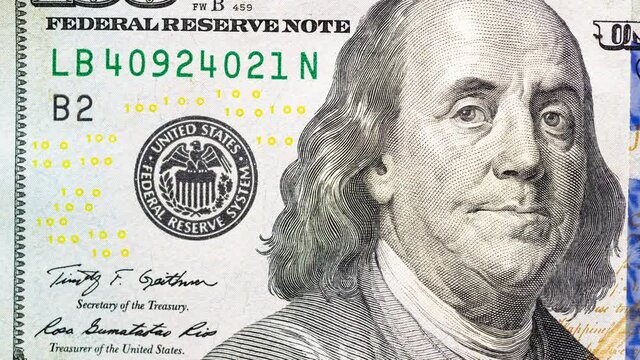 Closeup one hundred US dollar banknote in stop motion animation. View of green USD cash macro.