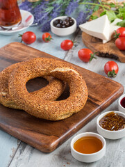 Turkish bagel and black Turkish tea on wooden table.