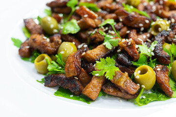 Fresh salad with roast pork, olives and cilantro
