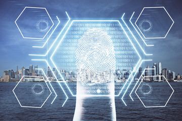 Double exposure of finger print hologram and cityscape background. Concept of personal security.