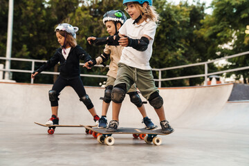 Happy kids on skateboards at the ramp