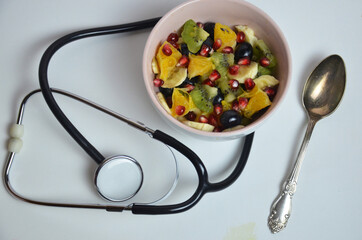 Doctor advises. Heart of vegetables and stethoscope isolated on white background