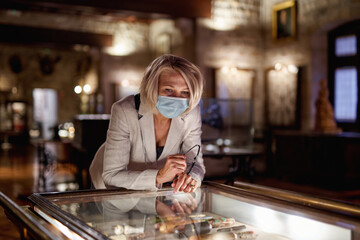 Woman looking expositions in museum