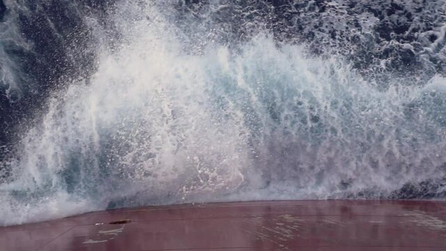 Wave splashing against the board of the ship.