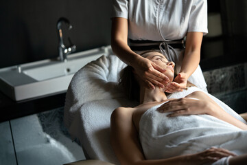 Health, beauty, resort and relaxation concept. Beautiful woman in spa salon getting massage