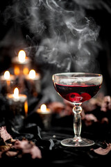 Red gothic Halloween drink with candy eyeballs and candles