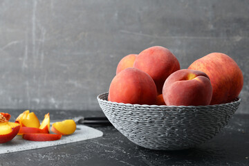 Sweet peaches in bowl on table