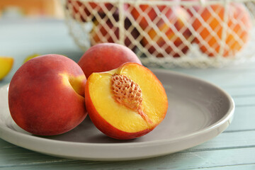 Plate with sweet peaches on table, closeup