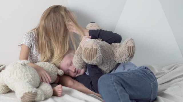 Children secretly hug each other. Brother and sister cute cuddle and tickle each other