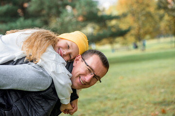 Father and son in the autumn park. active games.