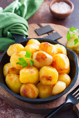 Naklejka na ściany i meble Whole potatoes fried in a pan, pushkin potatoes, selective focus