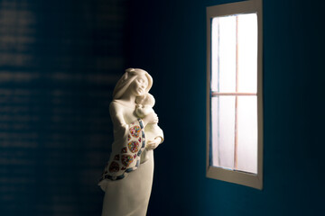 statua maternità donna bimbo abbraccio alla finestra