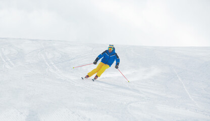 Fototapeta na wymiar Skier on piste in high mountains