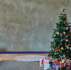 Close up beautiful and big Christmas tree, grey stone wall, gift box and carpet on the brown parquet.