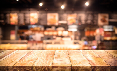 Wood table top (Bar) with blur light bokeh in dark night cafe,restaurant background.