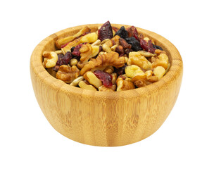 Side view of a wood bowl filled with healthy trail mix on a white background.