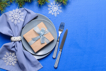 Christmas table setting on color background