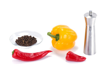 a set of delicious and fragrant peppers and a metal pepper mill