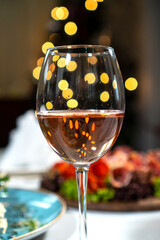 WIne glass on the holiday table against the bokeh lights