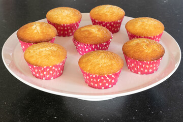 Home baked cupcakes in dark background, pink with dots
