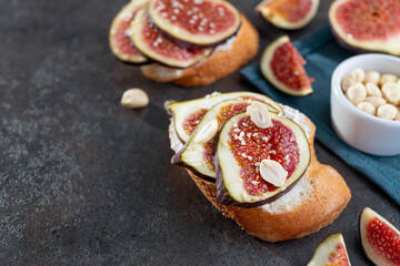 Tasty bruschetta with cream cheese, figs