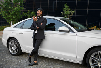 Smiling dapper Arabic Muslim businessman wearing Keffiyeh and arms crossed