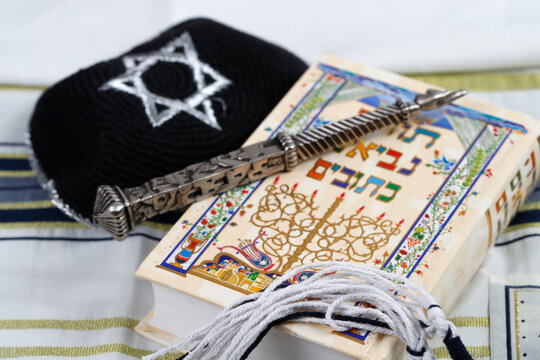 Silver yad, black and white tzitzit, tallit, kippah and Torah, Jewish symbols, France