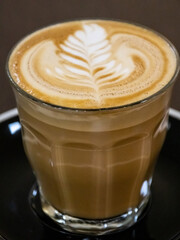 Closeup of a Glass of Coffee Latte on a wooden table in a Sydney Cafe